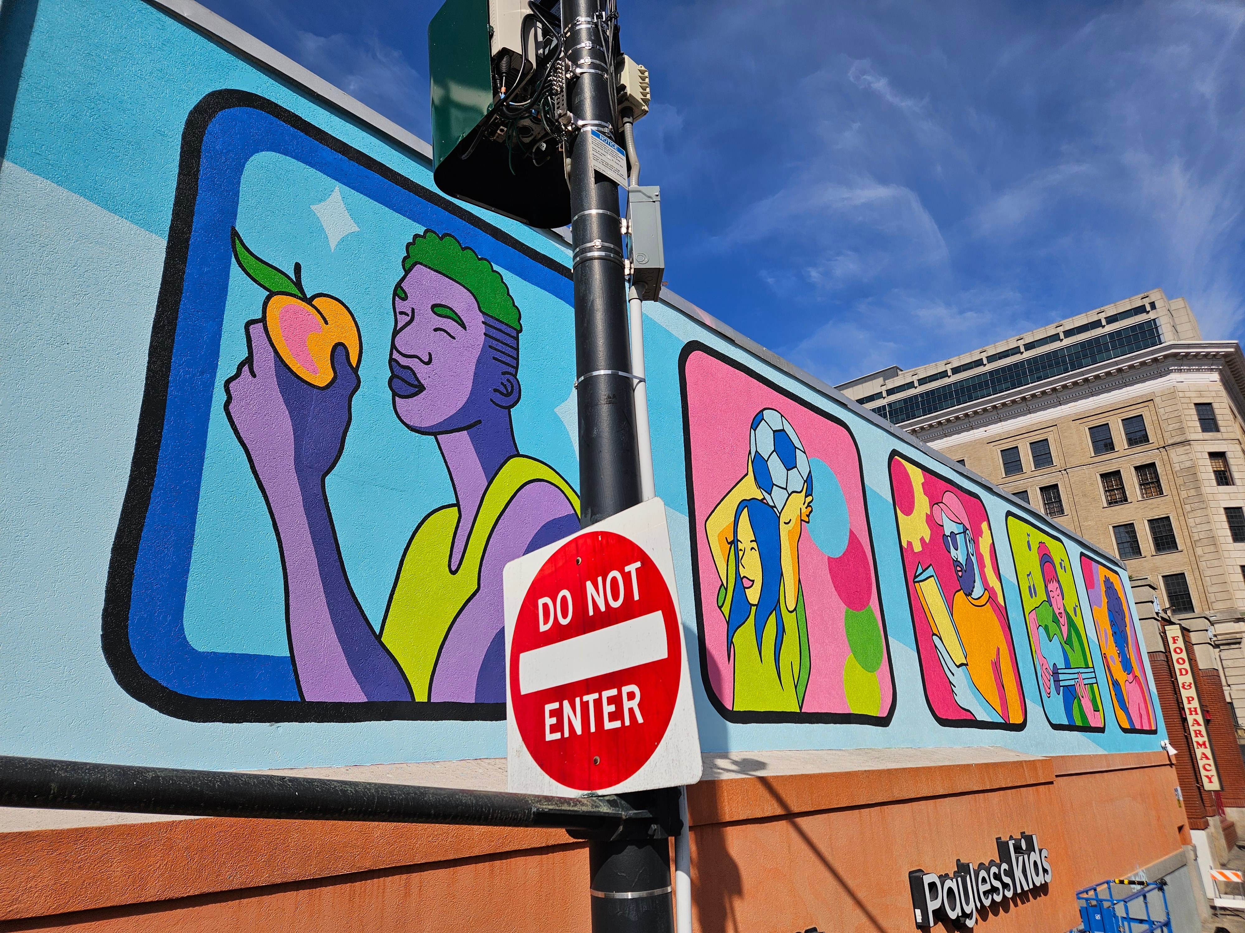Photograph of a vibrant public mural in Atlanta rendered in bold colors